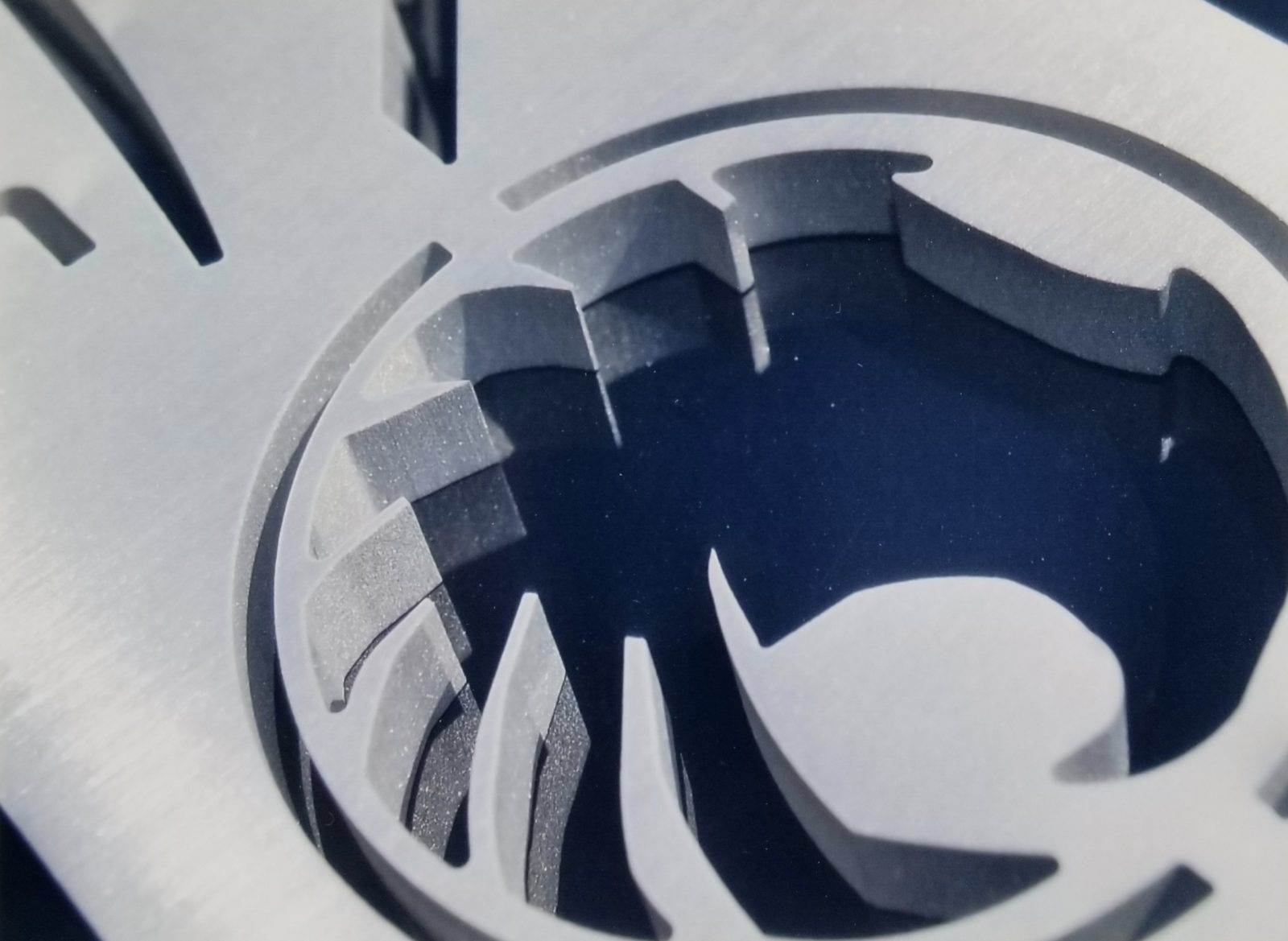 Precision waterjet-cut phoenix logo in metal plate